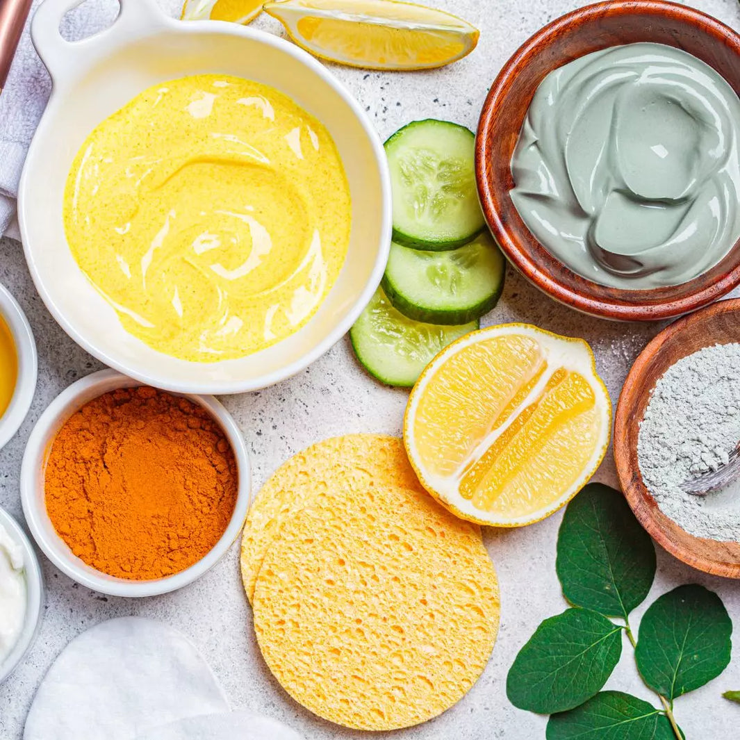 A flat-lay image featuring a variety of skin-friendly foods such as berries, spinach, citrus fruits, and avocado, arranged next to skincare products like moisturizers and serums.